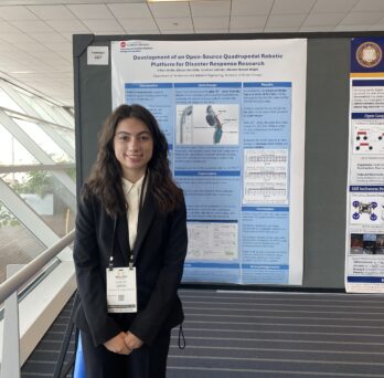 a student standing in front of a research poster